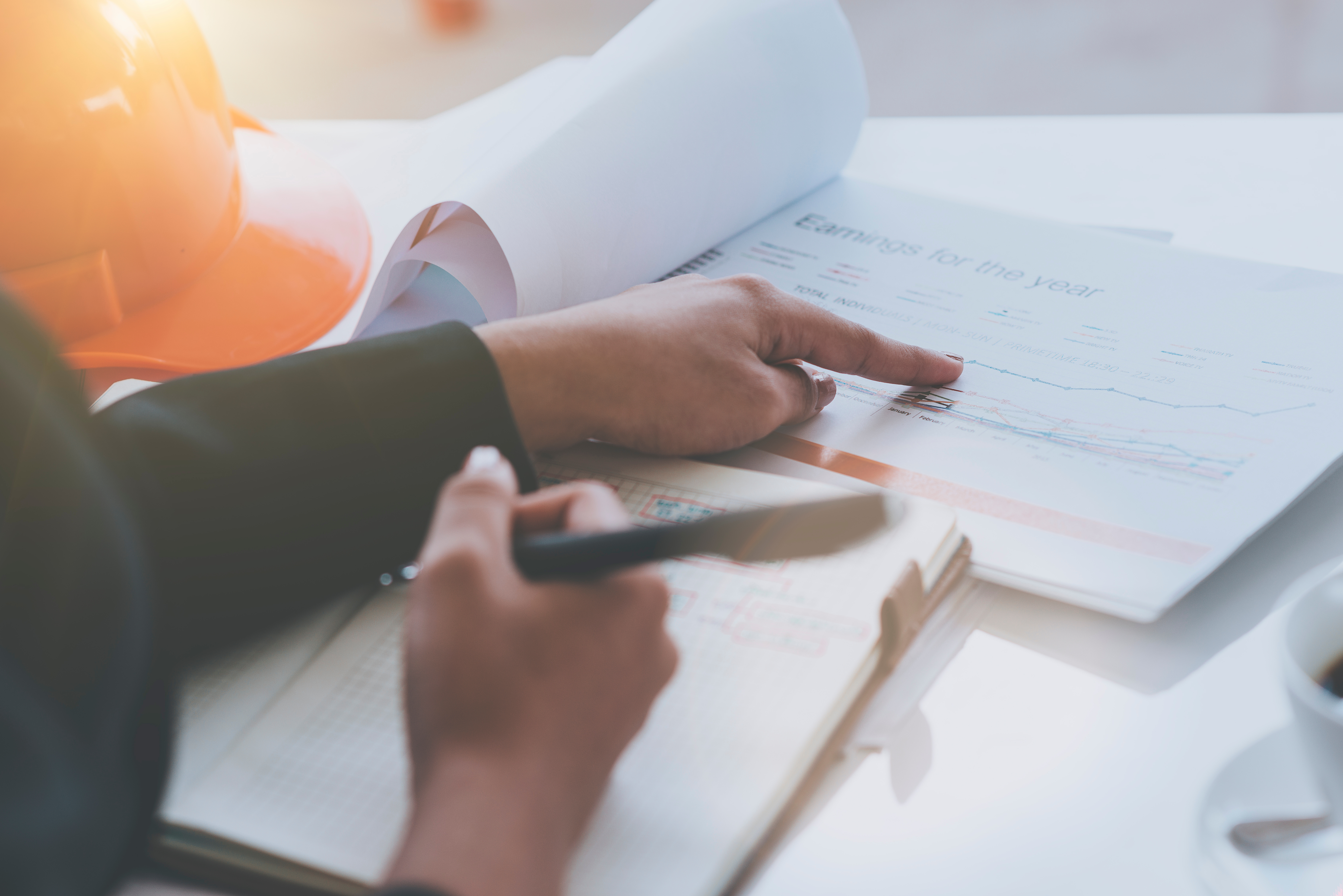 a person's hand checking through a document